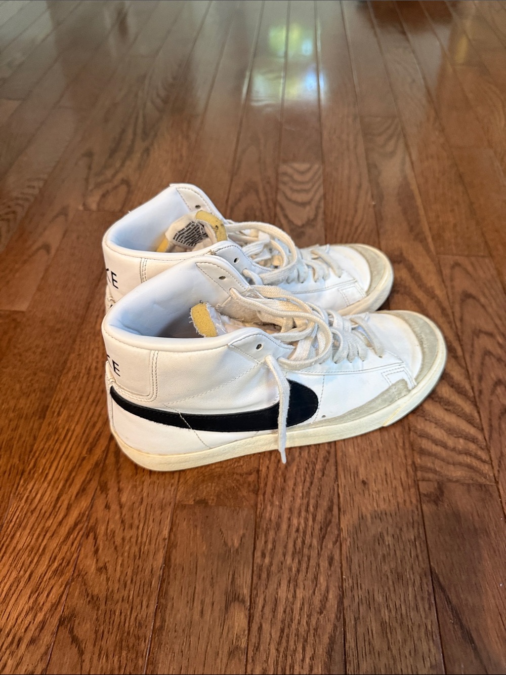 Nike White High-Top Sneakers with Black Swoosh